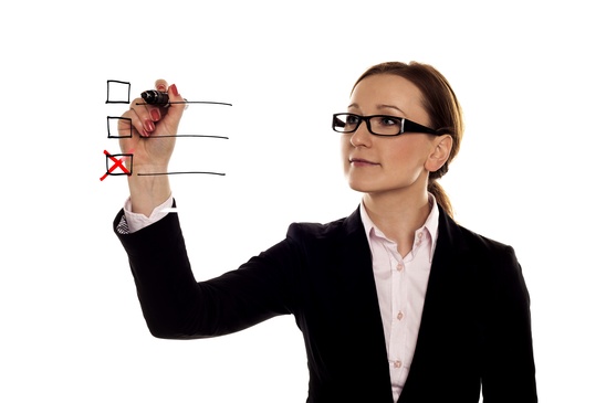 Businesswoman Checking Off Item on a Checklist