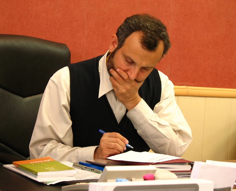 Exhausted Man Doing Paperwork
